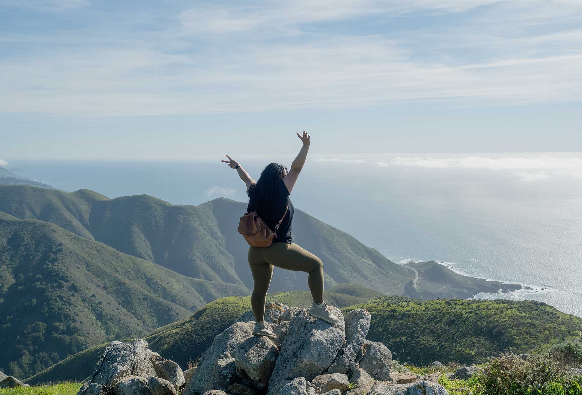 Woman on top of mountain in Big Sur, CA