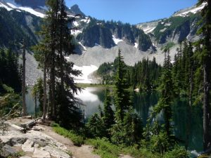 Panoramic view of a river flowing through rugged mountains in a national park, perfect for adventure and wellness vacations.
